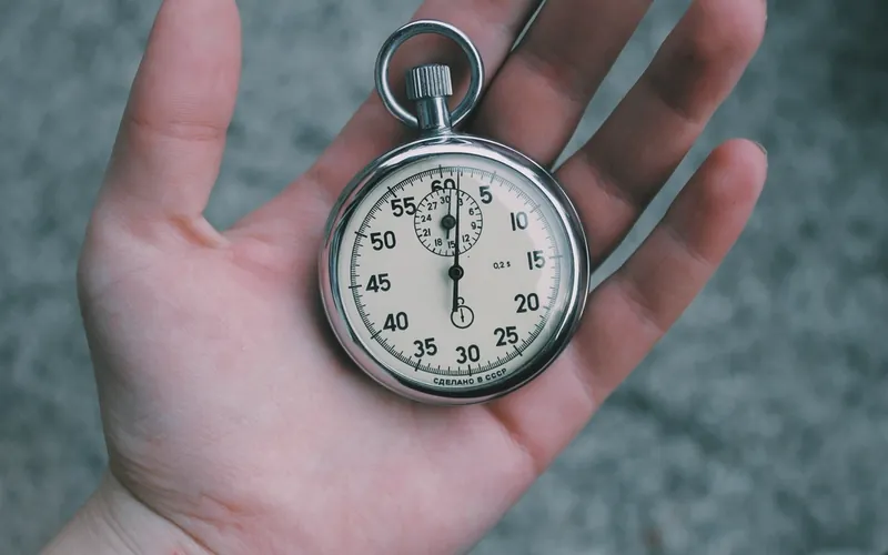A stopwatch held in an open hand
