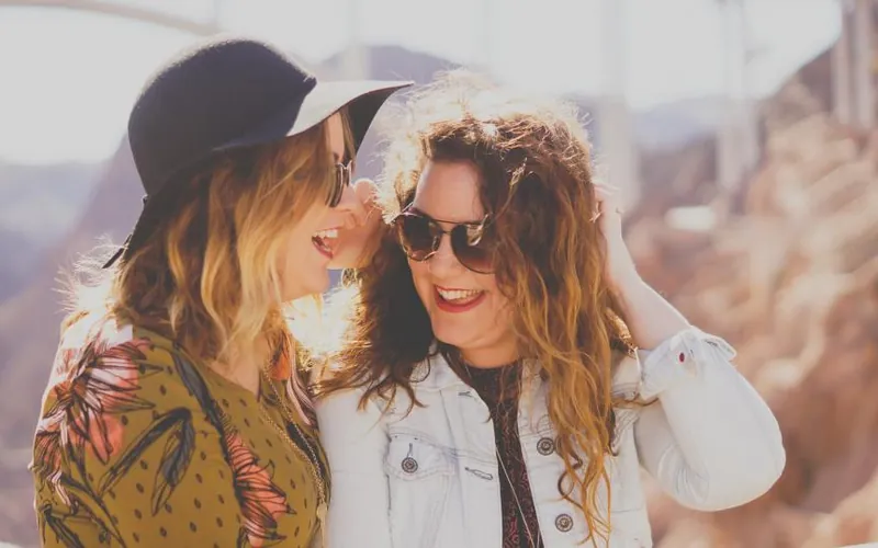 Two friends whispering a plan